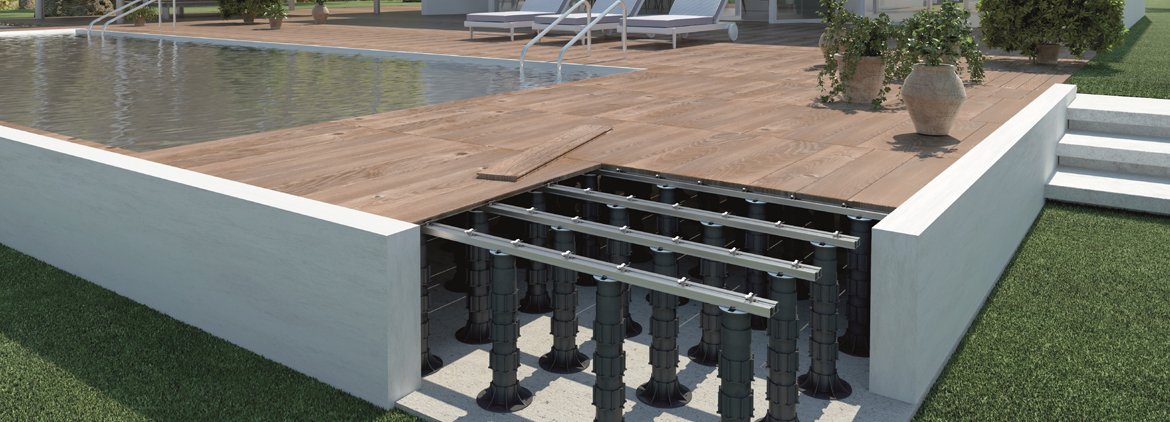 Paver pedestal system supporting deck planks with exposed support structure