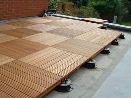 Roof deck pedestal system with wooden tiles on adjustable pedestals